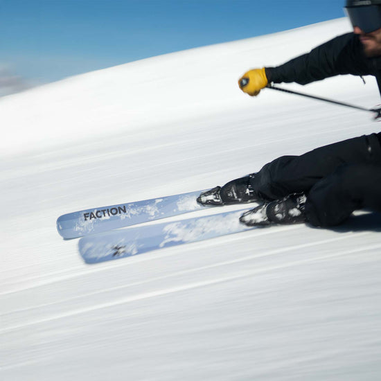 Skier carving on gray Faction Dancer 1 piste skis