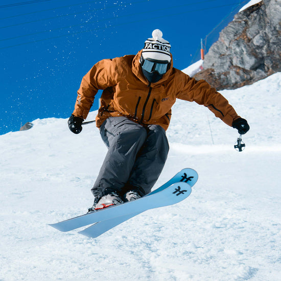 Skier jumping on blue Faction Dancer 2 all-mountain skis