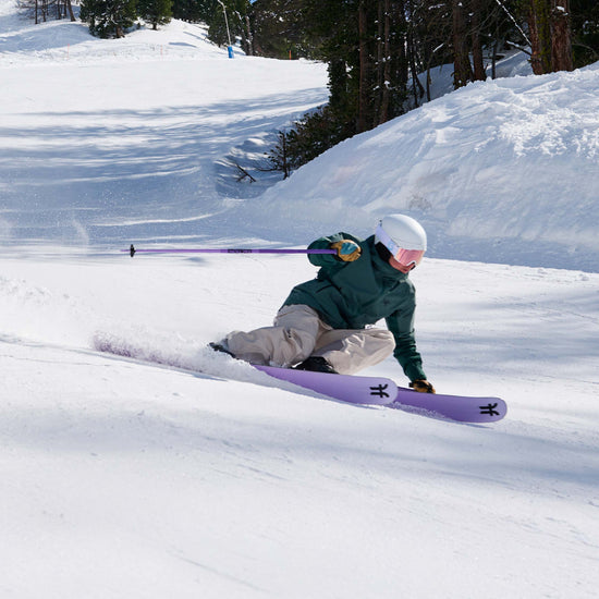 Girl skier carving on purple Dancer 2 all-mountain skis
