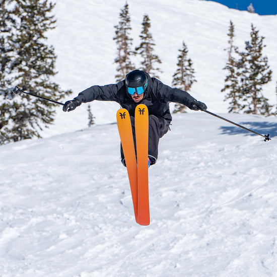 Freeride Skier jumping on orange Dancer 3 Freeride and all-mountain skis