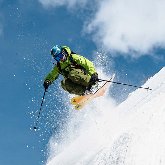 Freeride skier jumping on yellow Dancer 4 Freeride and powder skis
