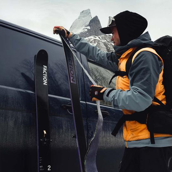 Skier putting skins on Faction La Machine 2 touring skis