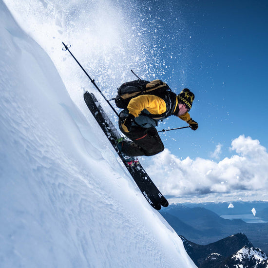 Skier jumping using Faction La Machine 3 black and purple touring skis