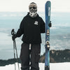 Man wearing a balaclava holding the Faction Studio 1 in an alpine setting.